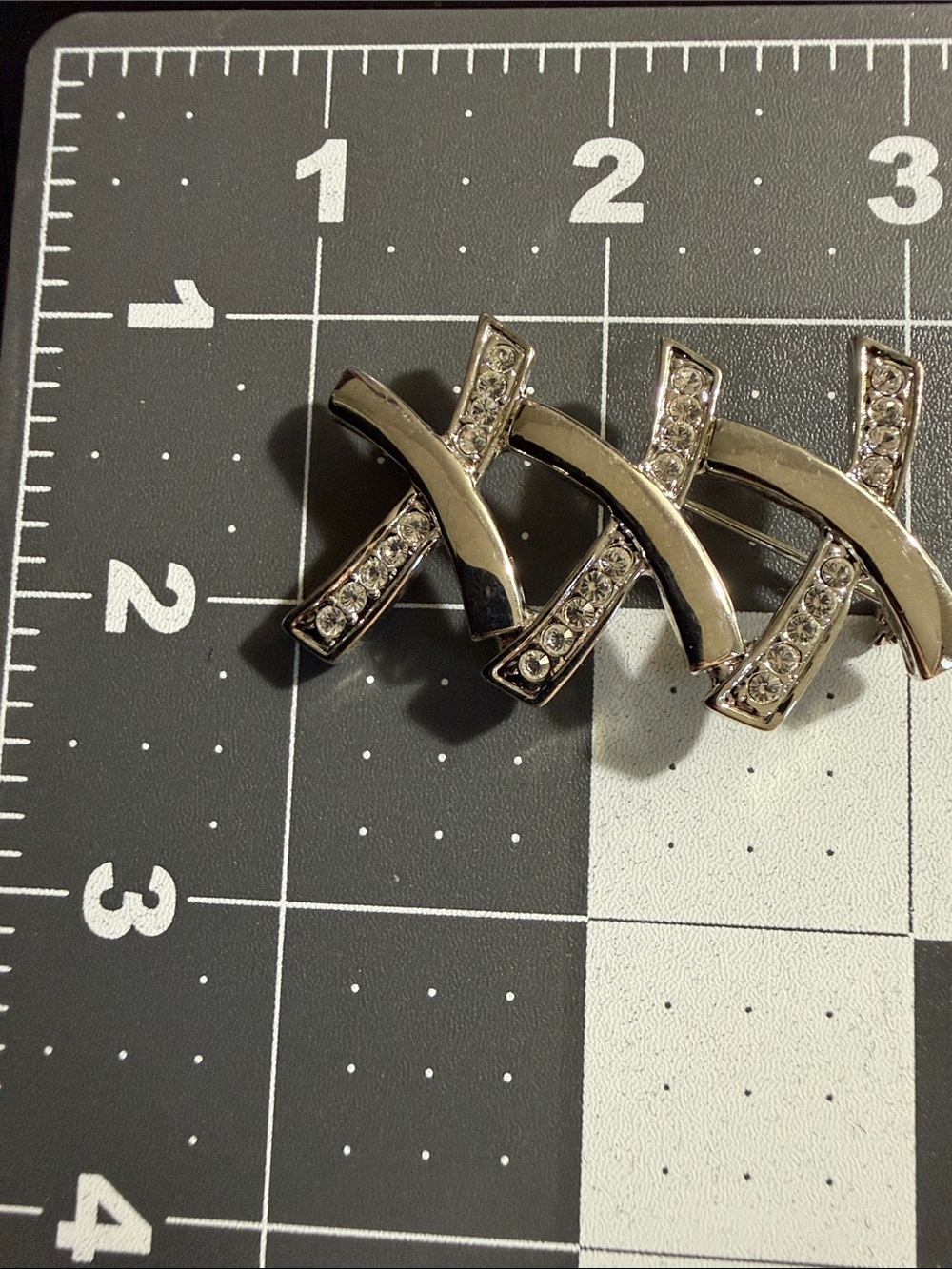XXX brooch an abstract geometric design with clear rhinestones in silver tone